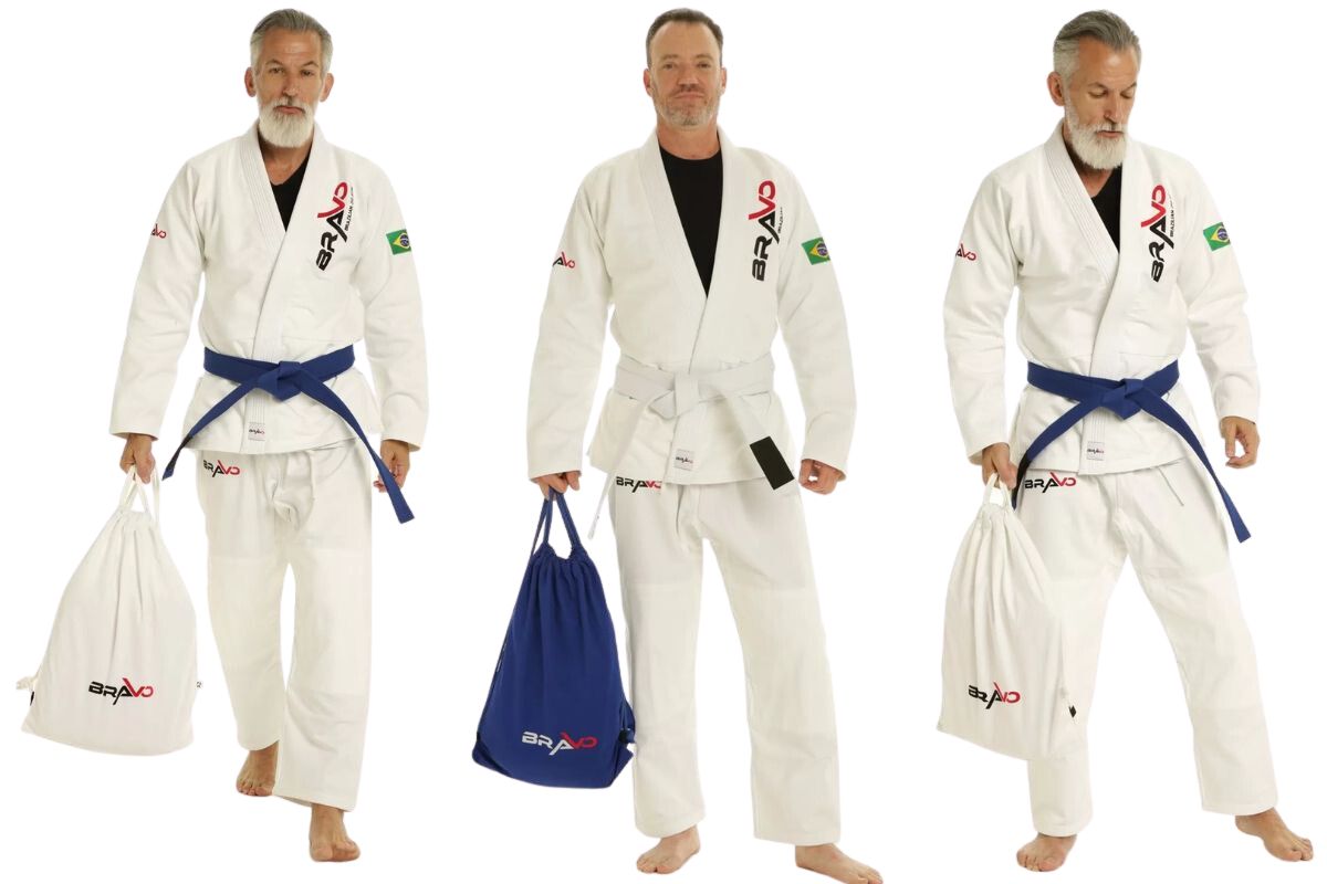 Three men in white BJJ gis holding Bravo branded drawstring bags in white and blue colors