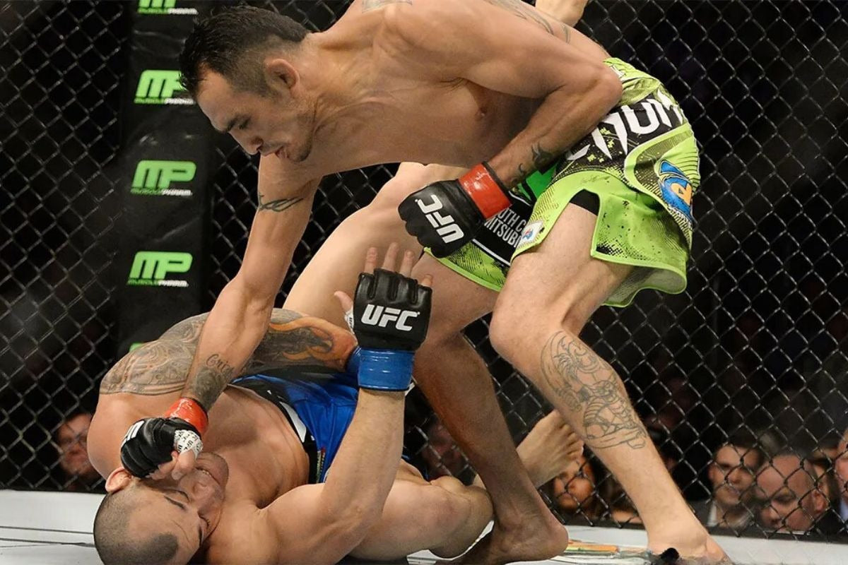 A UFC fighter delivers ground-and-pound strikes to an opponent on the mat during a match